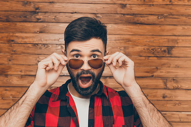 istock shocked sad young man in glasses with open mouth 636352814