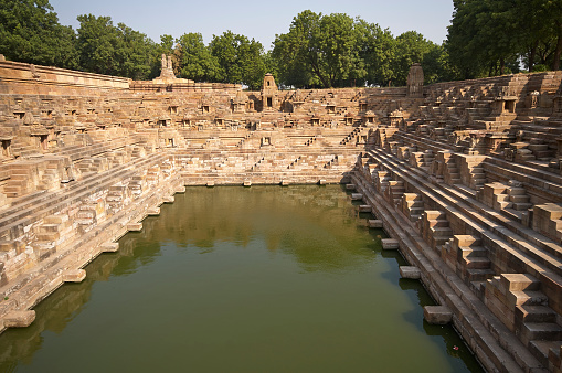Ancient stepped water tank in front of the Sun Temple at Modhera. Ancient Hindu temple built circa 1027. Gujarat, India.