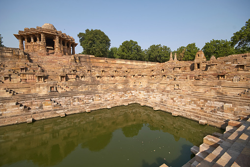 Ancient stepped water tank in front of the Sun Temple at Modhera. Ancient Hindu temple built circa 1027. Gujarat, India.