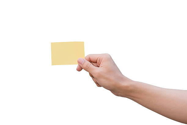 Hand holding yellow paper isolated on white Hand holding yellow paper isolated on white gift tag note photos stock pictures, royalty-free photos & images