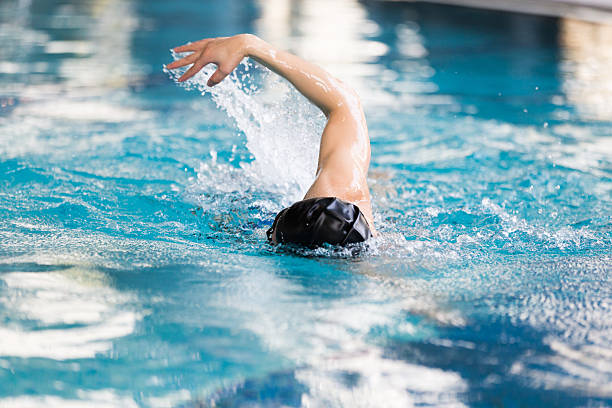 swimming man in swimming pool swimming man in swimming pool leisure facilities stock pictures, royalty-free photos & images