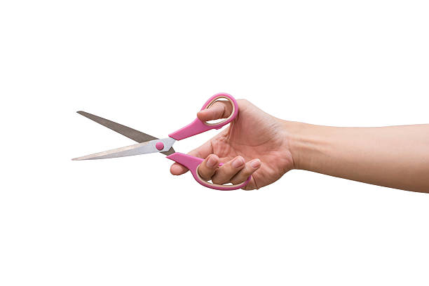 istock man hand holding scissors isolates on white background 636355350