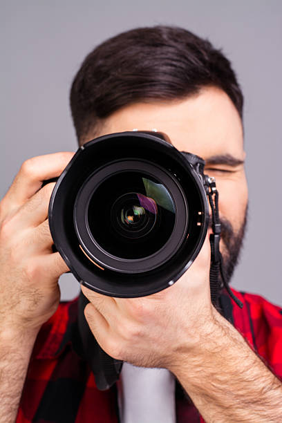 istock Close up photo of man's hands holding digital camera 636355492