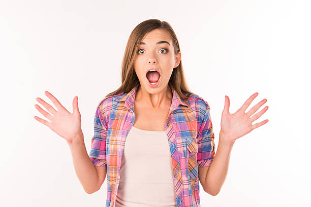 istock Funky emotions. Surprised young woman standing on a white  background 636357456