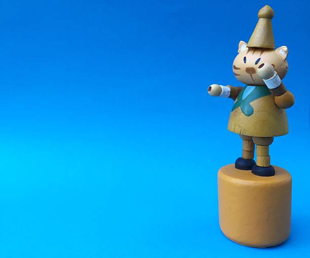 istock Cute cat wood toy on blue background 636358340