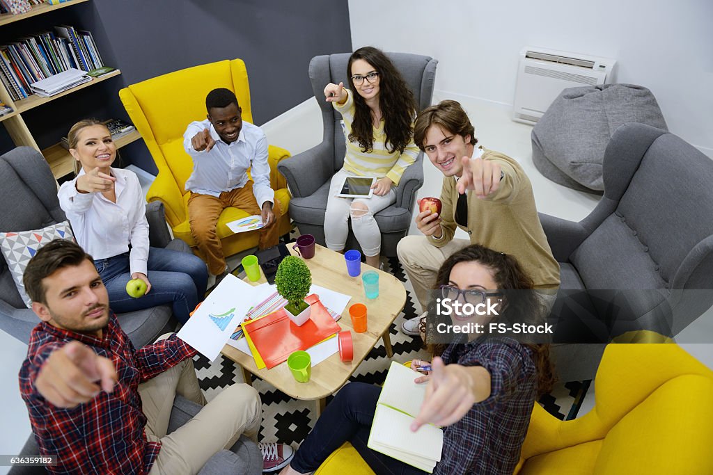 Young team of freelancers searching information making business tasks consulting Young team of freelancers searching information making business tasks consulting with expert. Students preparing presentation using technology modern laptop wireless internet connection in coworking Adult Stock Photo