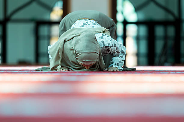 istock Young beautiful Muslim Woman Praying In Mosque 636359904