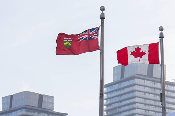 Canada and Ontario flags in front of skyscrapers in Toronto Toronto is the most populous city in Canada, the provincial capital of Ontario, and the centre of the Greater Toronto Area, the most populous metropolitan area in Canada. ontario flag stock pictures, royalty-free photos & images