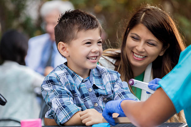 istock Young boy is treated at outdoor free clinic 636362026