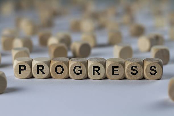 istock progress - cube with letters, sign with wooden cubes 636364518