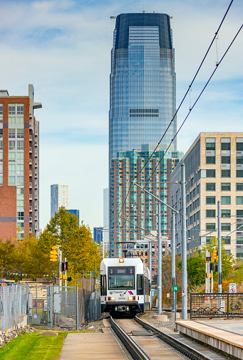 Jersey City, United States - October 28, 2014: NJ Transit Hudson Bergen Light Rail (HBLR) service to West Side Avenue approaches the Jersey Avenue HBLR Station on Regent Street.  The station services the Jersey City Medical Center and a large car park.  The popular HBLR has three lines totalling 21 miles (34km) of track linking residential Bayonne and western Jersey City with the downtown business district and Hoboken rail and ferry terminals.  