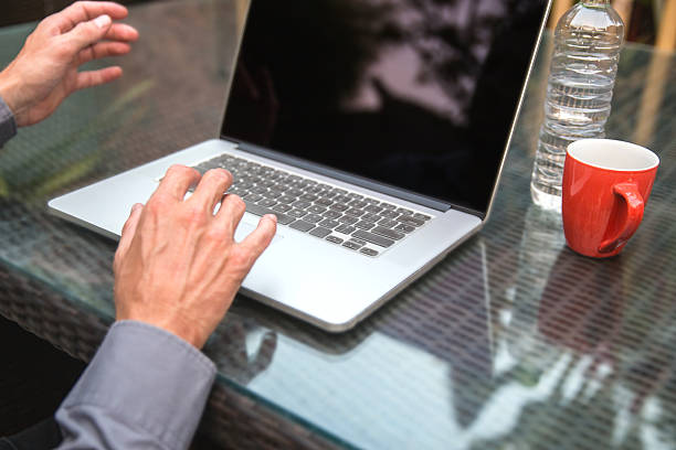 istock Adult man using laptop on business travel 636366046