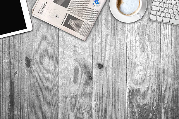 istock Daily newspaper and tablet pc on the wooden table. 636367806