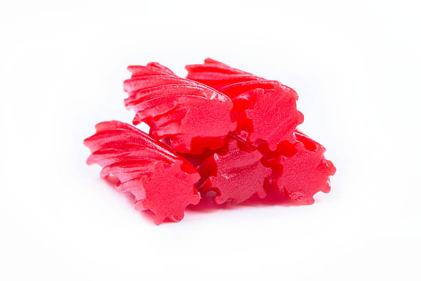 istock Strawberry Licorice pieces isolated on white background 636370368