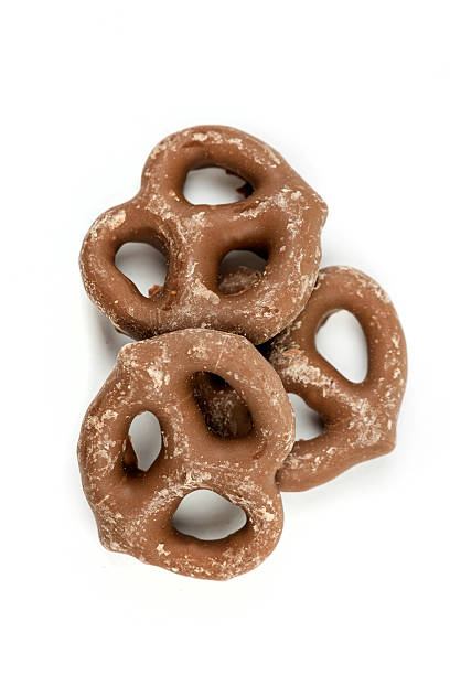 istock Chocolate covered pretzel isolated on white background 636371400
