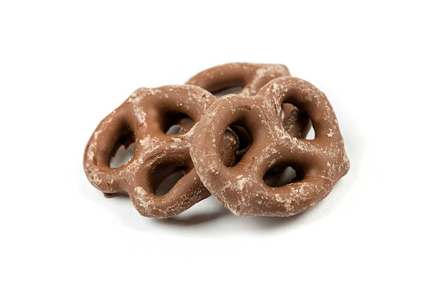 istock Chocolate covered pretzel isolated on white background 636371420