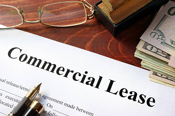 istock Commercial Lease agreement with money on a table. 636371484