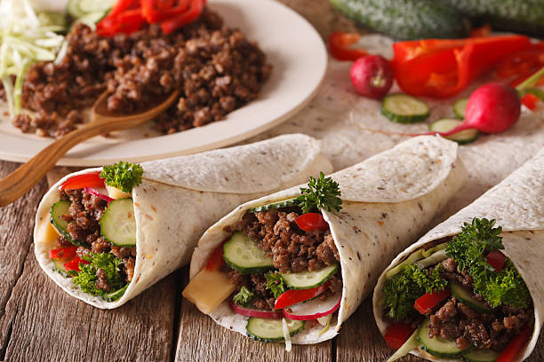 istock Tortilla rolls with minced meat, vegetables and ingredients 636372174
