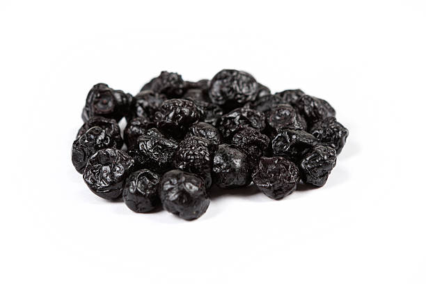 istock Dried blueberries isolated on white background 636372392