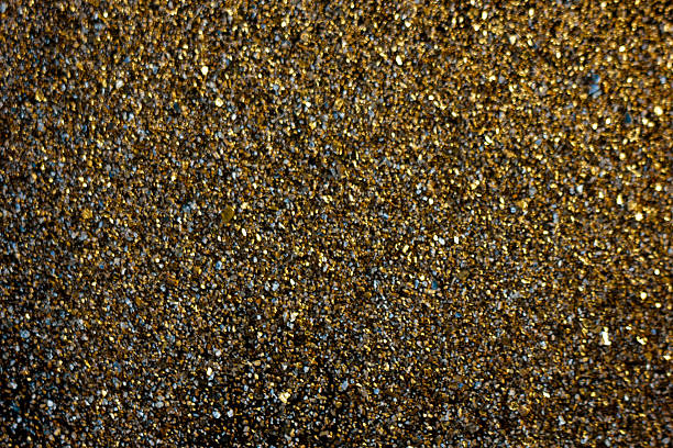 istock Golden background - dust of gold over black background. 636374270