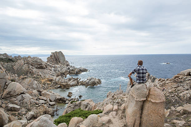 istock One young man relaxing by the sea 636377470