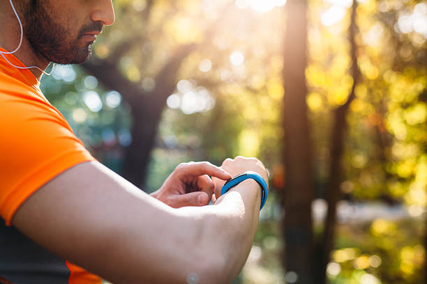 istock Sportsman using a smart watch 636377506