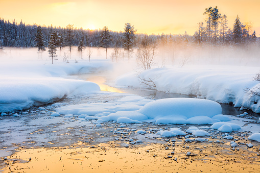 Winter sundown in forest and river with beautiful misty fog, fantastic winter nature landscape, wallpaper