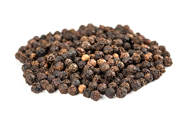 istock Pile of black peppercorns isolated on white background 636378662