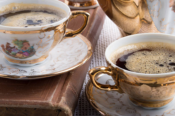 Vintage coffee break. Antique porcelain coffee cups with hot coffee close-up