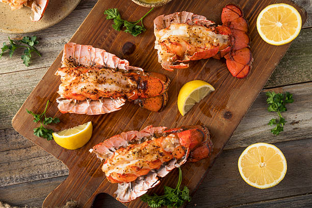 Seasoned Baked Lobster Tails Seasoned Baked Lobster Tails with Lemon and Butter Sauce lobster seafood photos stock pictures, royalty-free photos & images