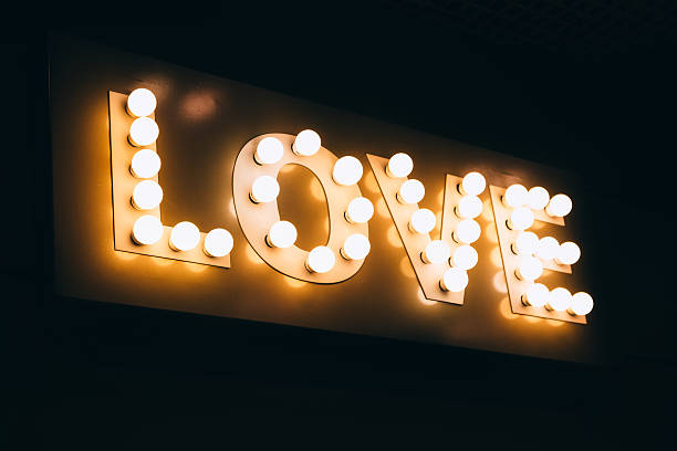 istock Love word made of glowing light bulbs. 636379190