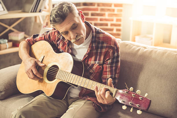 istock Handsome mature man with guitar 636385196