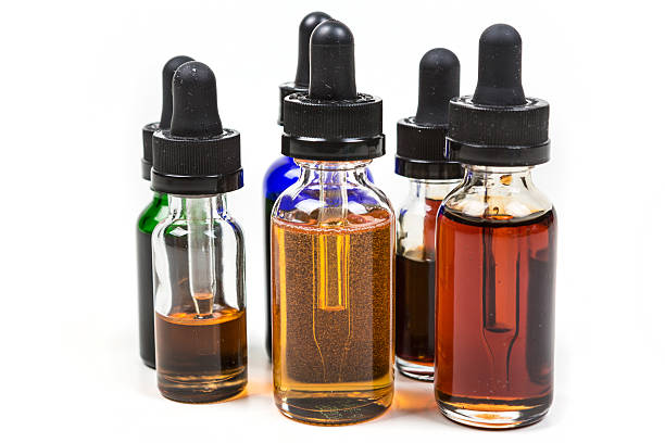 istock Assorted flavors of vape juice isolated on white background 636385354