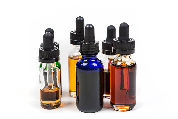 istock Assorted flavors of vape juice isolated on white background 636385370