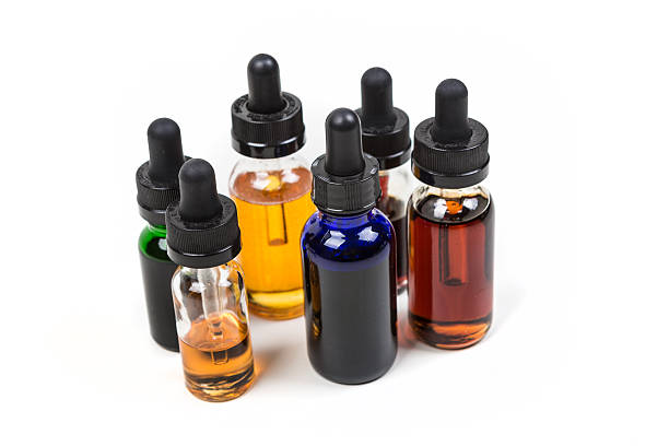 istock Assorted flavors of vape juice isolated on white background 636385390