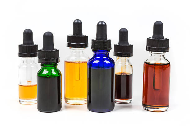 istock Assorted flavors of vape juice isolated on white background 636387354