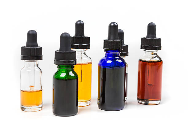 istock Assorted flavors of vape juice isolated on white background 636387374