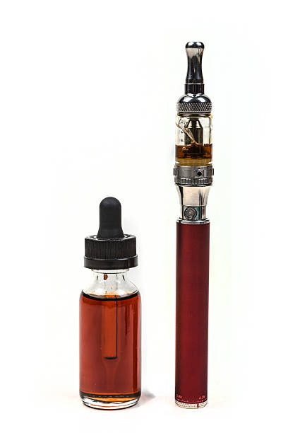 istock Ecigarette and flavored vape juice isolated on white background 636387402