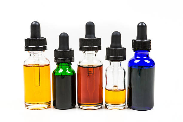istock Flavored vape juice isolated on white background 636387478