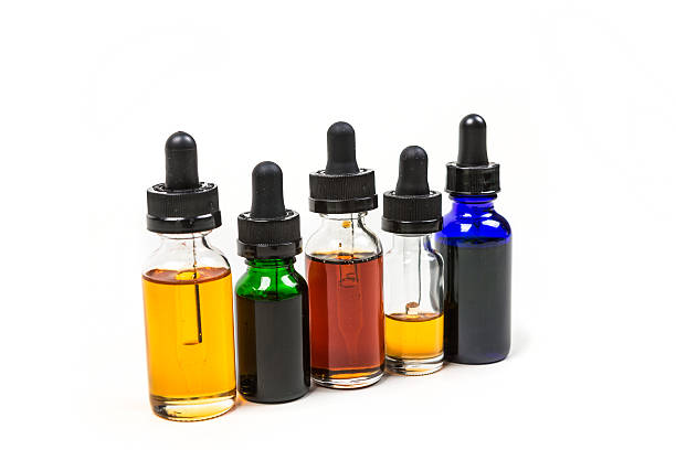 istock Flavored vape juice isolated on white background 636387490
