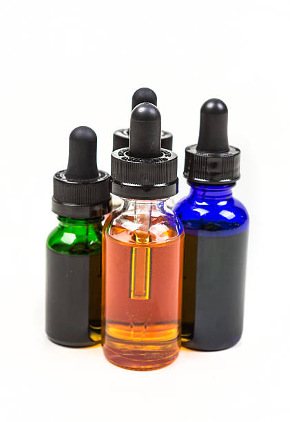 istock Flavored vape juice isolated on white background 636387548