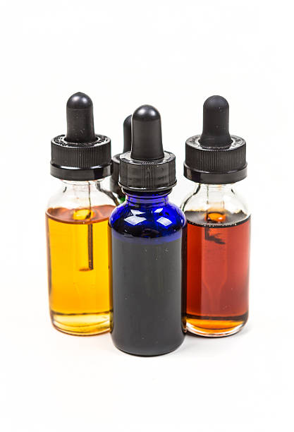 istock Flavored vape juice isolated on white background 636387558