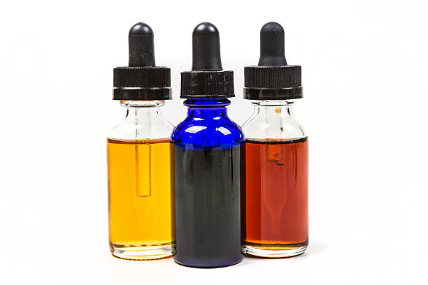 istock Flavored vape juice isolated on white background 636387578