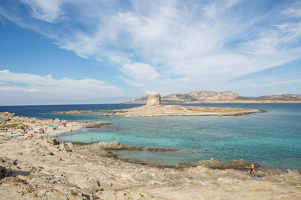 This is the beautiful beach of Stintino with a view to Torre Pelosa and the former prison island, now national park and marine biology research centre Asinara in the background.
