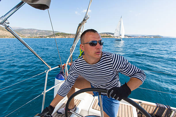 istock Man at the helm on the sailing boat. 636391872