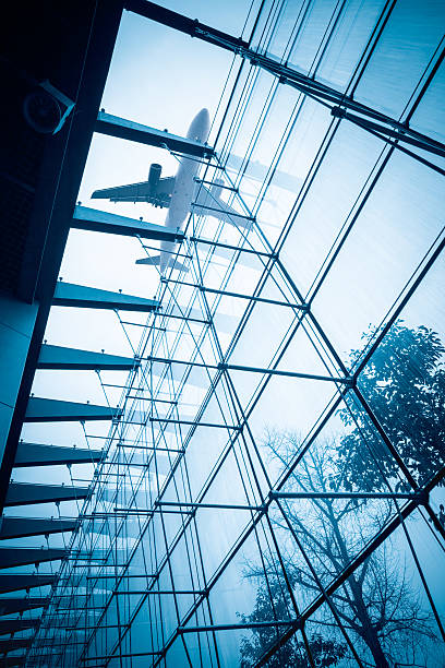 istock airplane above the glass building 636392742