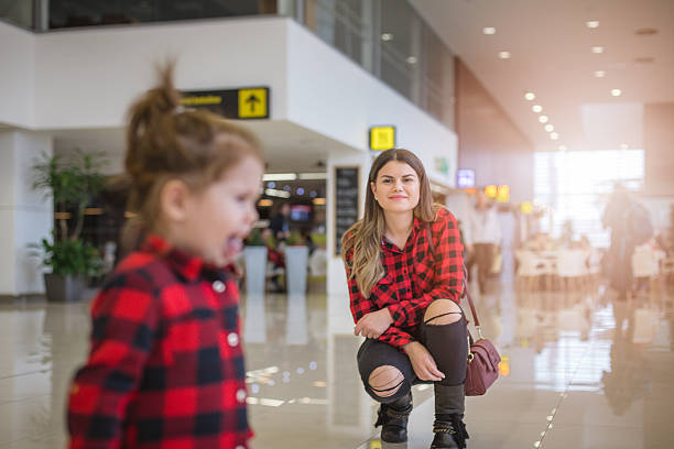 istock mother and daughter on a airport 636392954