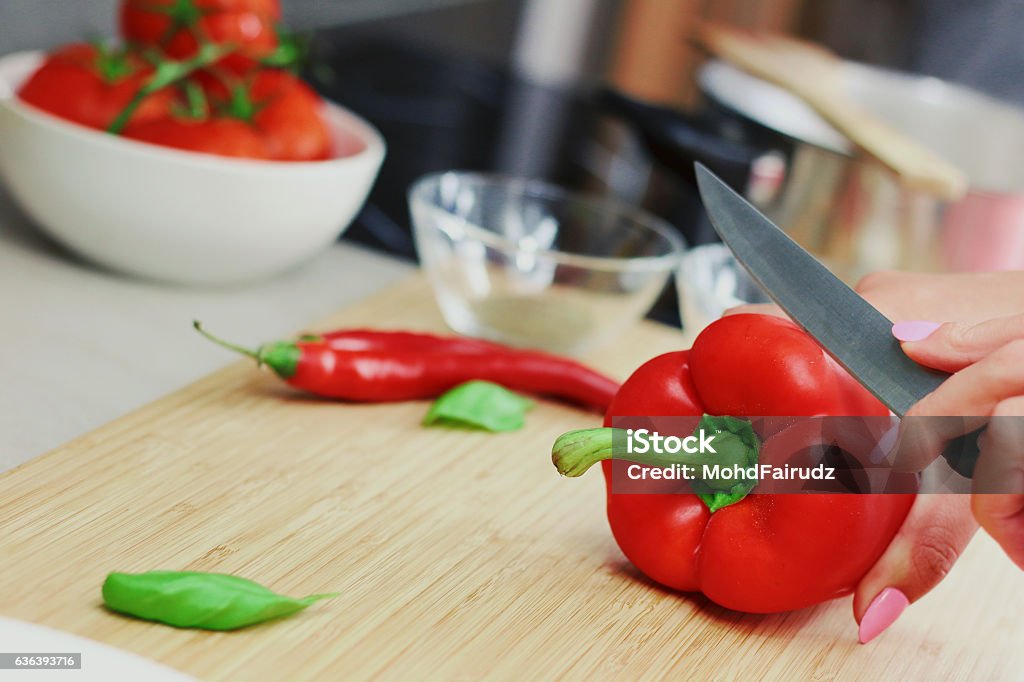Red pepper cutting with knife Backgrounds Stock Photo