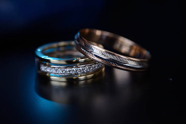 istock Beautiful wedding golden rings on dark background 636398946