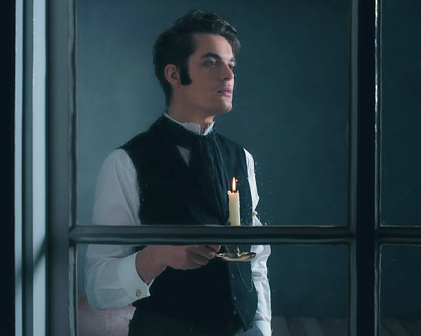 istock Retro dickens style man with candlestick looking out rainy window. 636399834